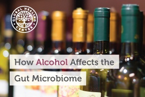 Several wine bottles on a shelf. Heavy alcohol consumption can lead to an imbalance of the gut microbiota and negatively impact health.