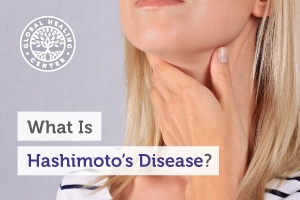 A woman is holding her throat. Hashimoto’s Disease occurs when the immune system deviates from its normal function.