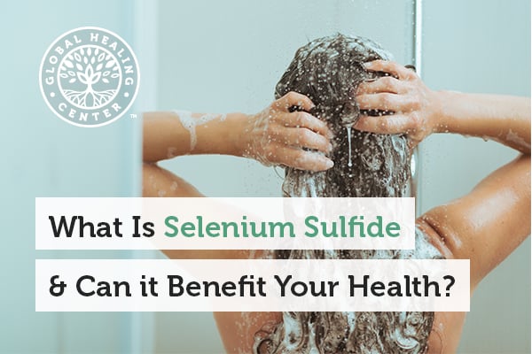 A woman is applying shampoo in the shower. Selenium sulfide is commonly found in cream, foam, shampoo, or in liquid form.
