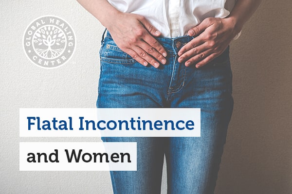 A person is holding their abdominal area. Flat incontinence can occur at any time.