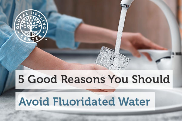 A person is filling up their cup with water. Fluoridated water can cause health issues.