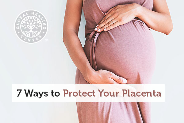 A pregnant woman is holding her stomach. Placenta helps balance the bacteria in your gut.