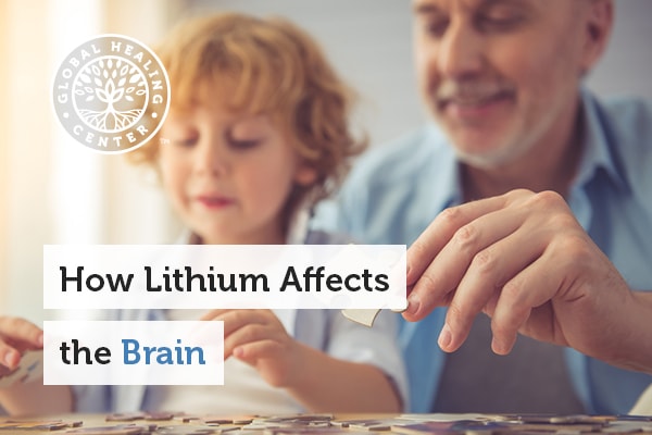 A grandfather and son working on a puzzle. Lithium effects on the brain.