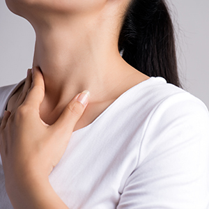 Woman with fingers on her neck.